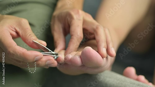 Husband cuts his wife's toenails