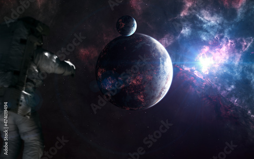 Inhabited planets of deep space. Astronaut out of focus. Science fiction. Elements of this image furnished by NASA