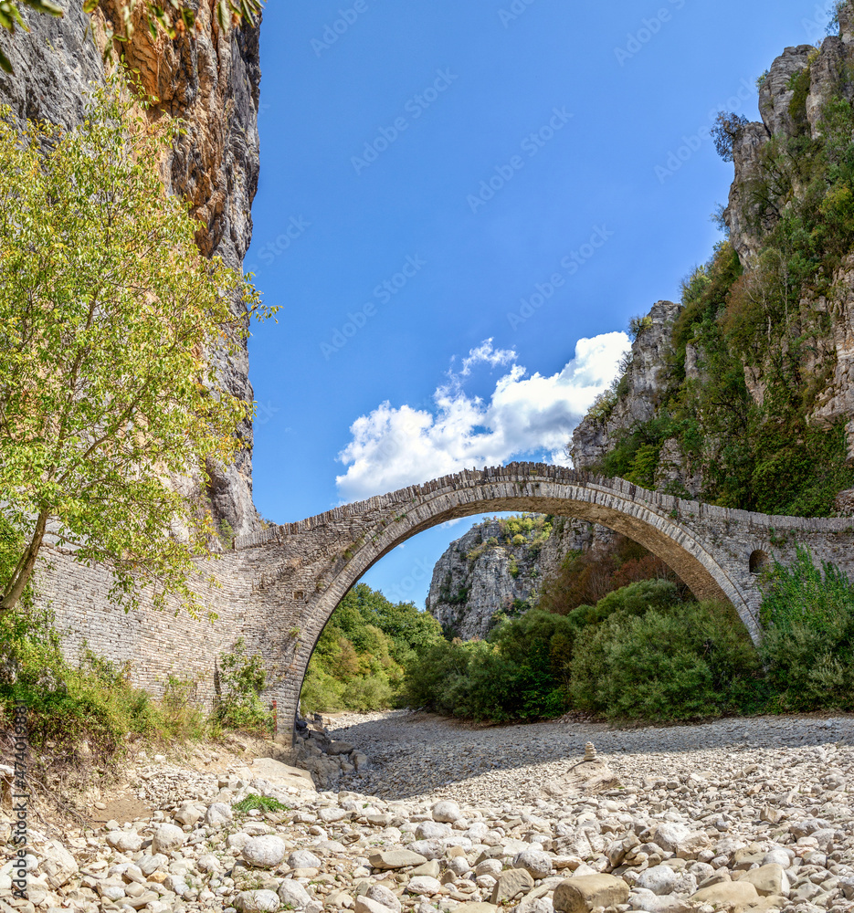 Greece, Epirus, Zagori, Old arch bridge in Vikos-Aoos National Park during summer Greece, Epirus, Zagori, Old arch bridge in Vikos-Aoos National Park during summer
