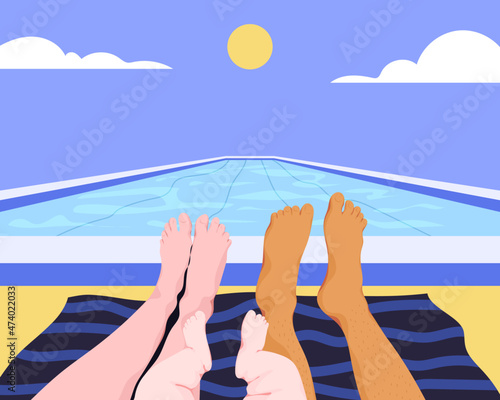 Family laying down next to swimming pool
