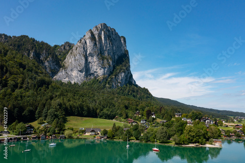 Austria, Upper Austria, Plomberg, Drone view of lakeshore village at foot of Drachenwand mountain photo