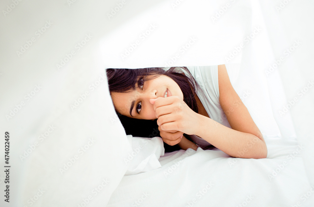 young pretty tann woman in bed among white sheets having fun, trying to sleep, fooling around young pretty tann woman in bed among white sheets having fun, trying to sleep, fooling around
