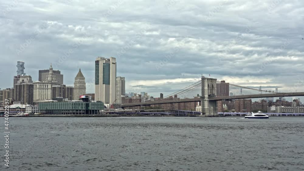 New York, Manhattan, NY, USA. September 28, 2021.View of Pier 17 at Seaport in Manhattan and the Brooklyn Bridge. The white ship of New York Water Taxi sails along the rugged East RiverNew York New York, Manhattan, NY, USA. September 28, 2021.View of Pier 17 at Seaport in Manhattan and the Brooklyn Bridge. The white ship of New York Water Taxi sails along the rugged East RiverNew York