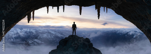 Dramatic Adventurous Scene with Man standing inside an Alien like Rocky Cave Landcspae. 3d Rendering. Sunset Sky. Aerial Mountain Image from British Columbia, Canada. Adventure Concept Artwork photo