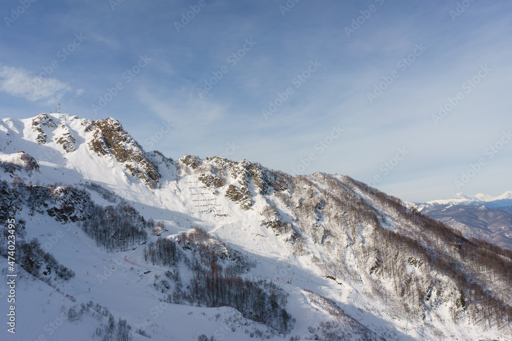 Fototapeta premium Alpine landscape, slopes of high mountains with glaciers against the blue sky.