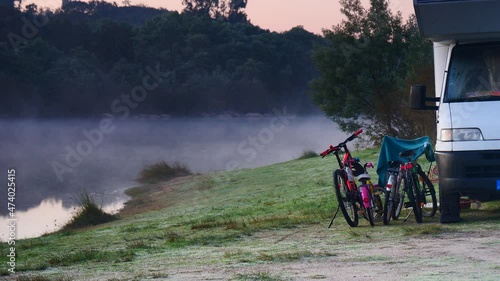 Caravan family vacation. Fog over lake in morning and camper camping on shore. Povoa e Meadas Dam in Castelo de Vide, Alentejo Portugal. photo