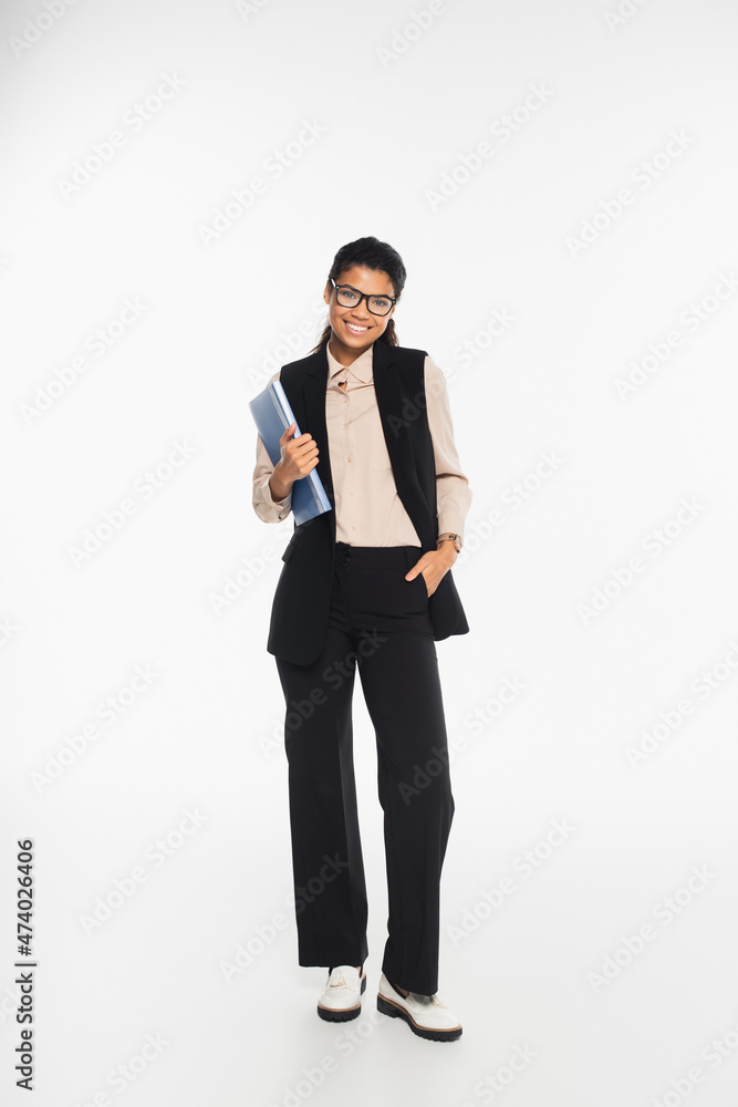 Cheerful african american businesswoman holding paper folder and looking at camera on white background. Cheerful african american businesswoman holding paper folder and looking at camera on white background.