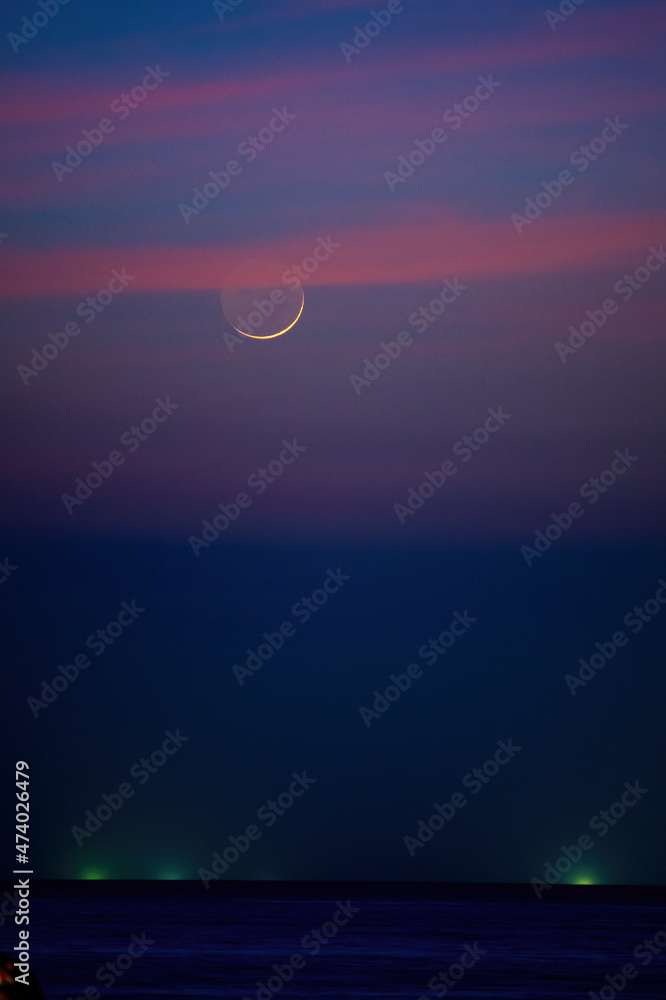 Twilight and crescent moon by the sea in Pattaya Bay Twilight and crescent moon by the sea in Pattaya Bay