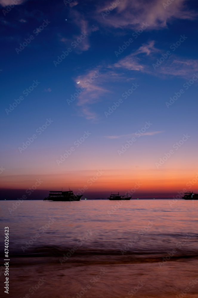 Twilight and crescent moon by the sea in Pattaya Bay