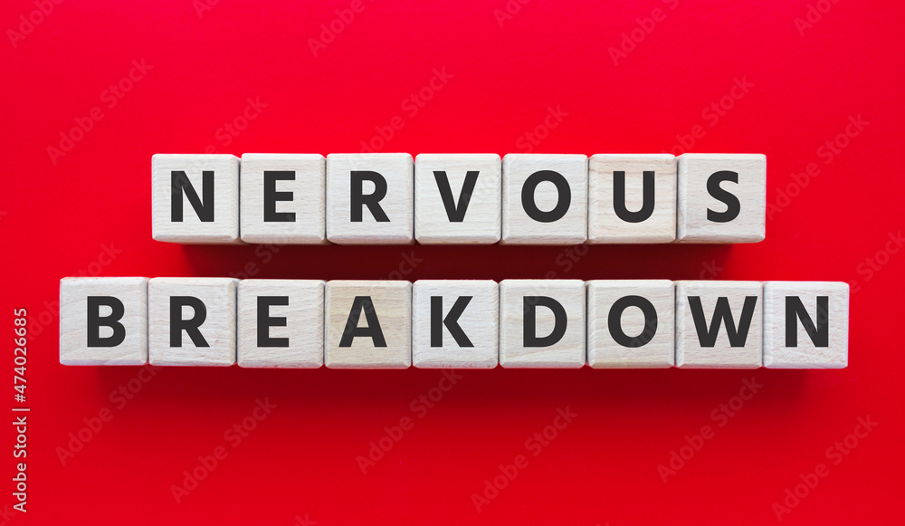 Text NERVOUS BREAKDOWN on wooden cubes. Mental health, disorder. Flat lay, top view on red background. 