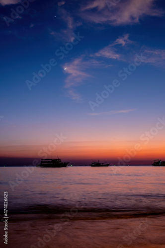 Twilight and crescent moon by the sea in Pattaya Bay © Arnon