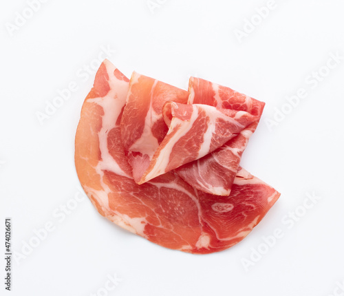Italian prosciutto crudo or jamon. Raw ham. Isolated on white background.