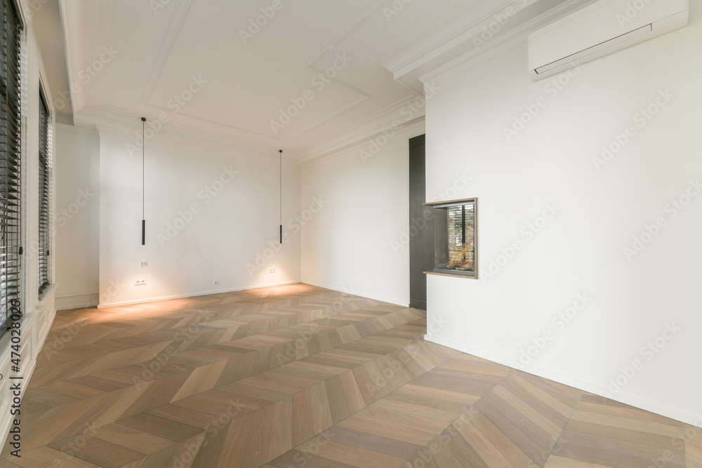 Spacious empty living room with parquet and artificial fireplace Spacious empty living room with parquet and artificial fireplace