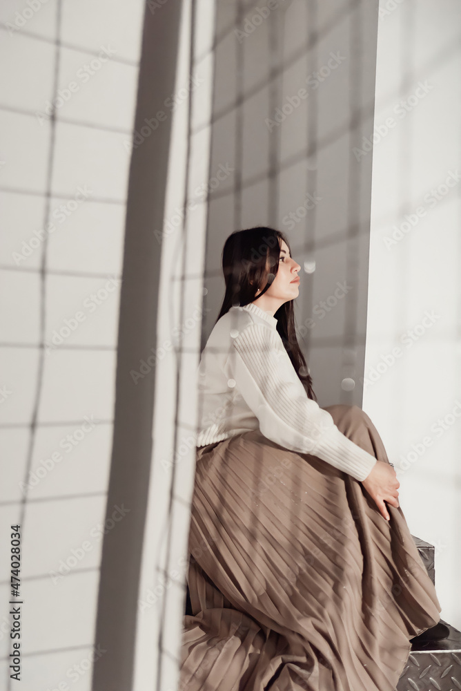 a young beautiful woman is sad behind the net as if in a cage a young beautiful woman is sad behind the net as if in a cage