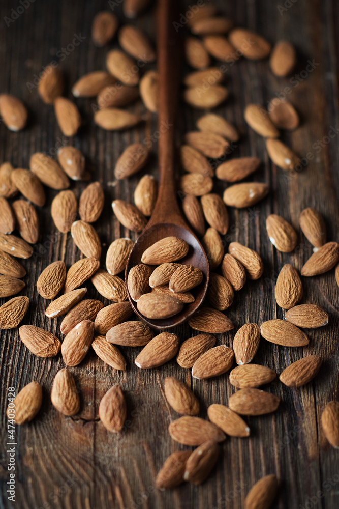 almonds on a brown wooden background almonds on a brown wooden background