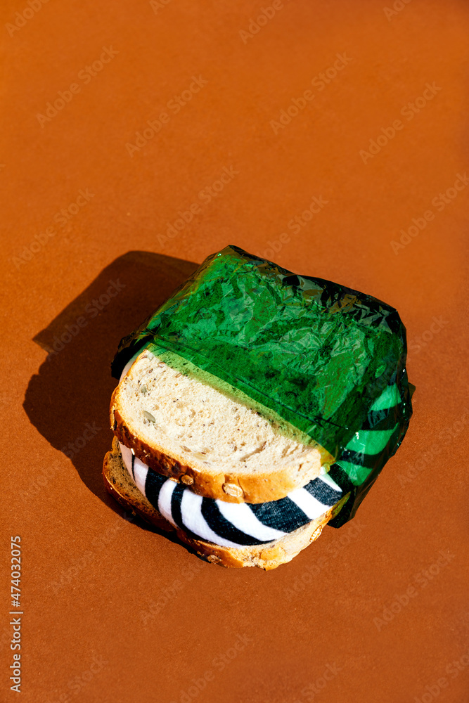 Sandwich in green plastic wrap Sandwich in green plastic wrap