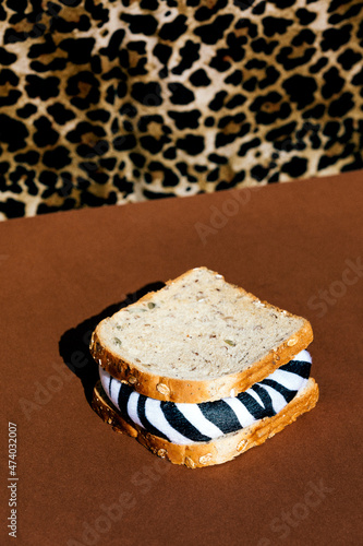Faceless person near sandwich with zebra filling