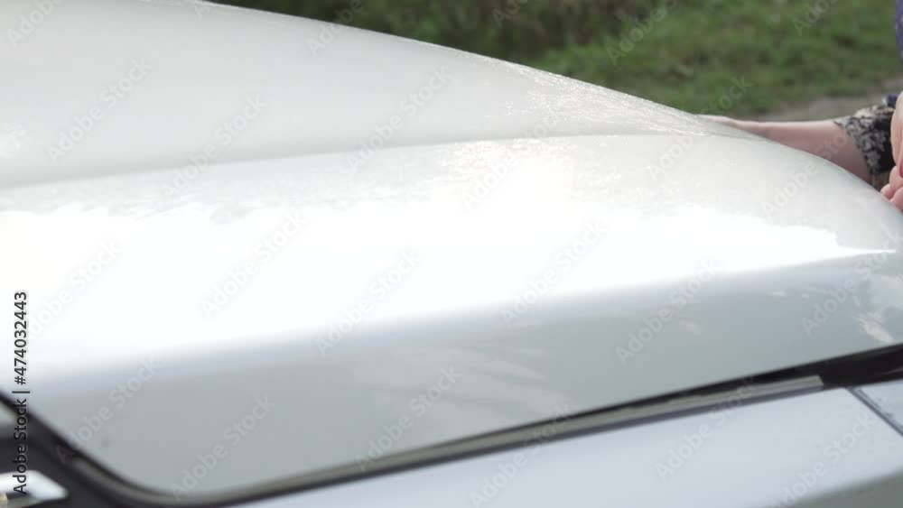 Woman measures the oil level of her car. Woman measures the oil level of her car.