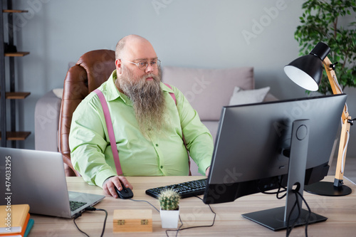 Portrait of attractive focused skilled guy manager agent broker copywriter typing e-mail letter at office indoor work place station photo