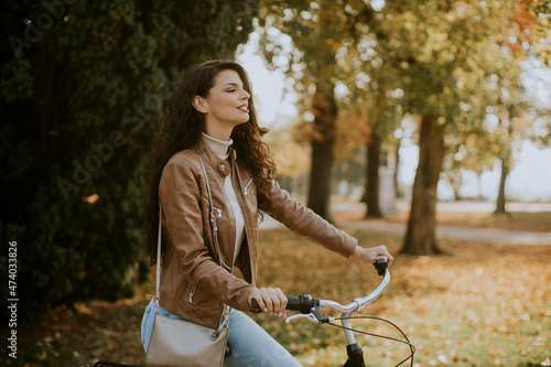Young woman riding bicycle ...