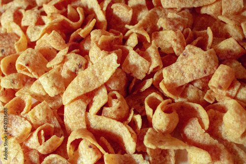 overhead view tasty snack corn chips pile on kitchen counter as junk food background photo