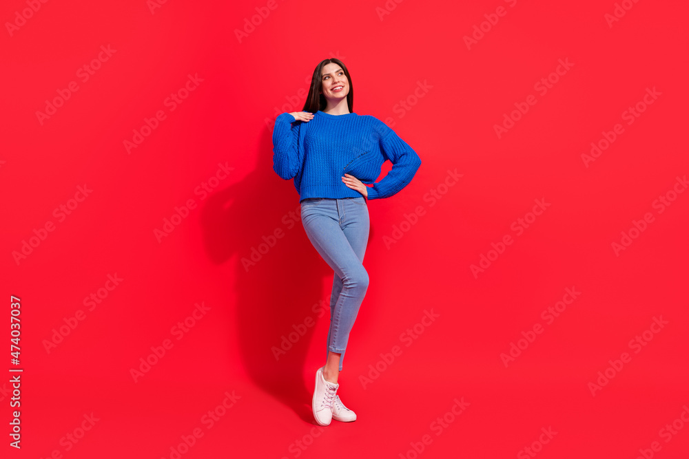 Full size photo of dreamy young charming woman look empty space smile isolated on red color background