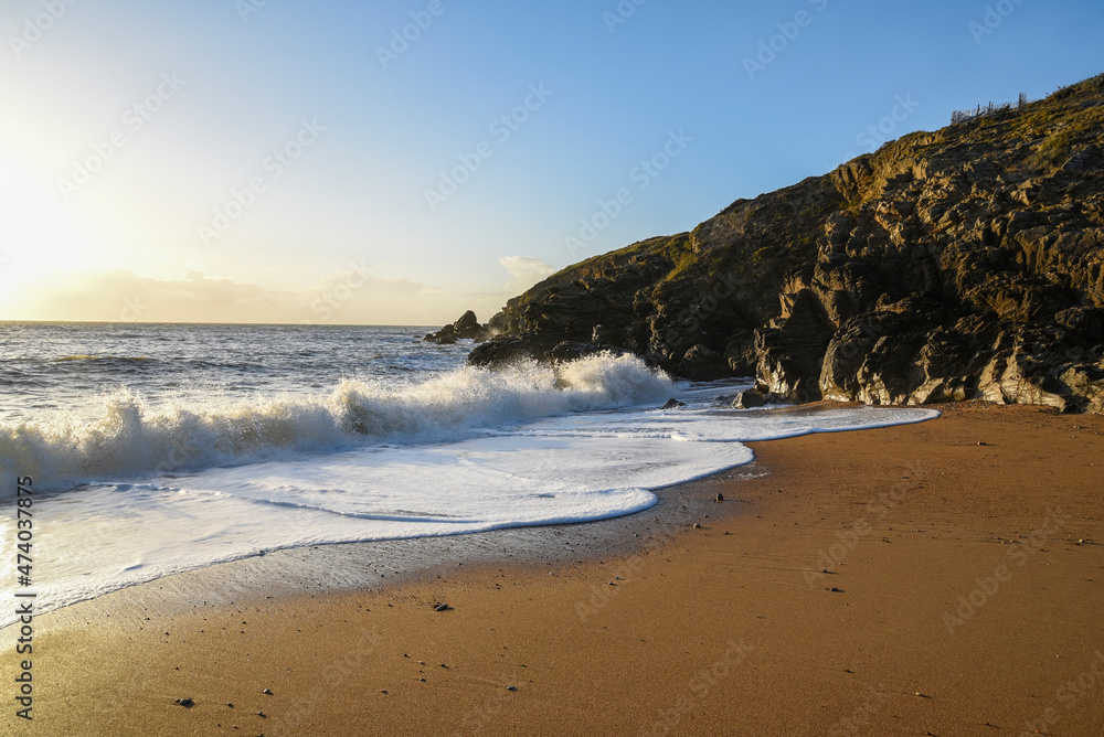 .Rocky coast of the Atlantic Ocean in France. Rocks and beach beautiful landscape at sunset.