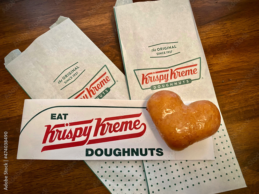 A Krispy Kreme Original Glazed heart doughnut with Krispy Kreme logo
