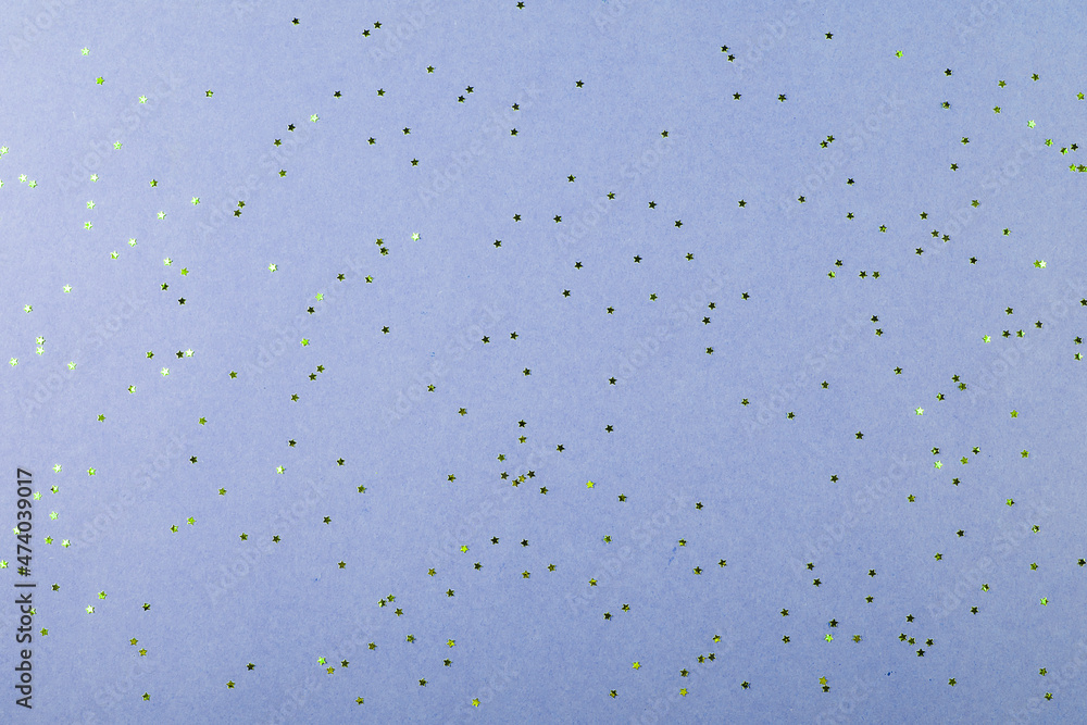 Blue background with little stars glitter confetti. Festive background. Color of the year 2022 Blue background with little stars glitter confetti. Festive background. Color of the year 2022
