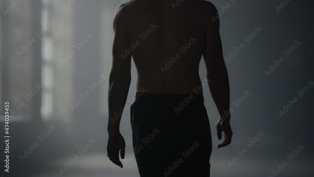 Fototapeta premium Guy walking in loft building. Male athlete finishing workout