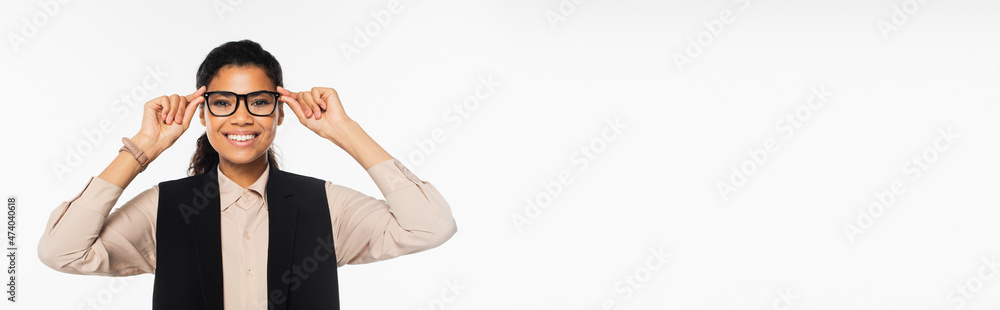 Happy african american businesswoman holding eyeglasses isolated on white, banner.