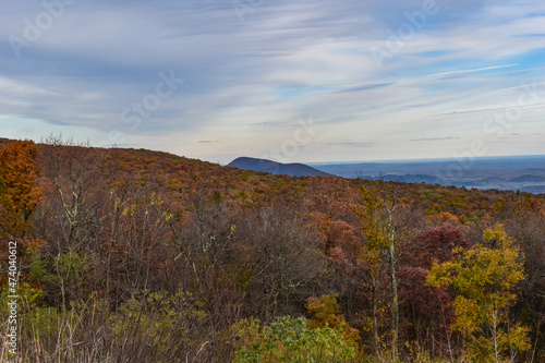 Shenandoah National Park, Virginia, USA - November 3, 2021: Mountain Scenery With Beautiful Fall Trees in the Foreground and a Bright Blue Sky in the Background