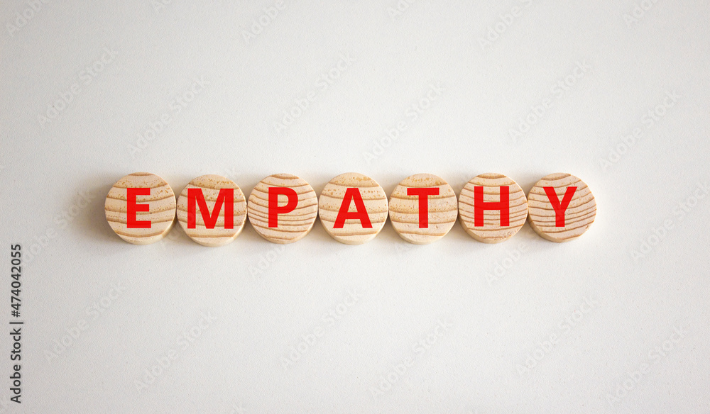 Empathy symbol. The concept word Empathy on wooden circles. Beautiful white background, copy space. Business, psychological and empathy concept. Empathy symbol. The concept word Empathy on wooden circles. Beautiful white background, copy space. Business, psychological and empathy concept.
