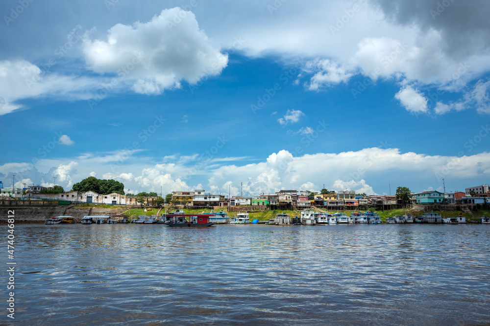 Beautiful view of Amazon River and Itacoatiara city skyline in summer sunny day with clouds. Manaus, Amazonas, Brazil. Concept of environment, ecology, nature, cityscape, travel, architecture.