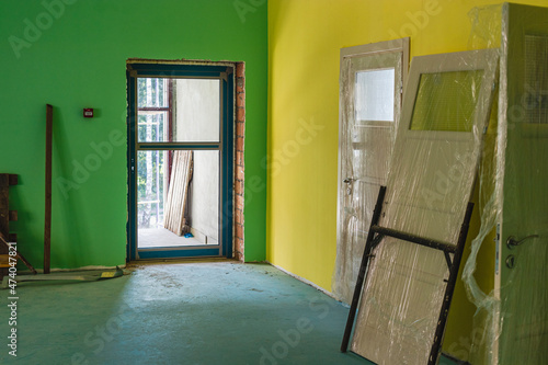 Painting the office space in bright colors. Installation of windows and doors. Renovation in a modern building. Interior decoration of premises.