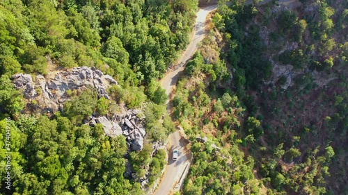 Aerial Beautiful View Of Car Moving On Mountain Road, Drone Flying Forward Over Green Landscape - Yahchouch, Lebanon photo