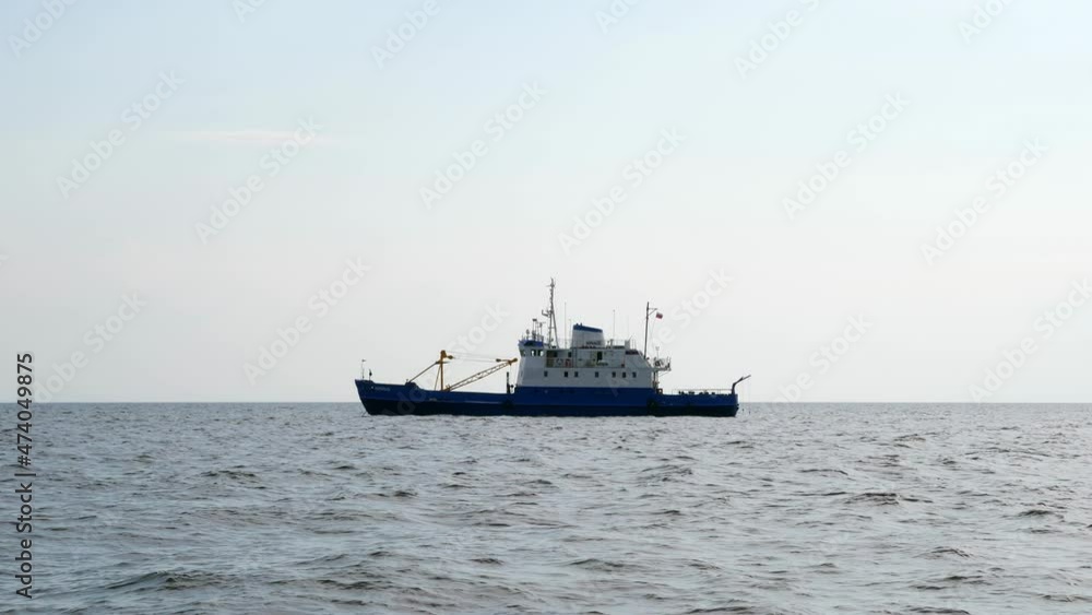 Old ship anchored at lake, side view of Norilsk ferry, icebreaker and buoy tender. Vessel stay at anchor near Sukho island at Ladoga lake, shot in summer day Old ship anchored at lake, side view of Norilsk ferry, icebreaker and buoy tender. Vessel stay at anchor near Sukho island at Ladoga lake, shot in summer day