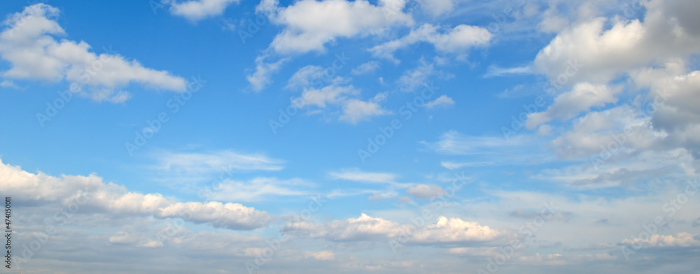 Blue sky background and clouds. Wide photo.