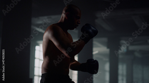Male boxer kicking punch bag. Man practicing kicks on sports bag © stockbusters