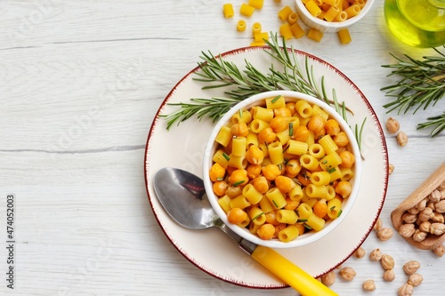 Italian Traditional Dish"Pasta e ceci alla Romana",Italian pasta with chickpeas,anchovy,rosemary,garlics,olive oil,salt and peppers on bowl with white wood table background.Top view.Copy space