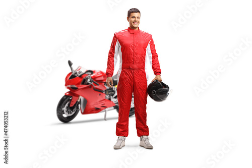 Konstfotografi Full length portrait of a racer with a red motorbike holding a helmet