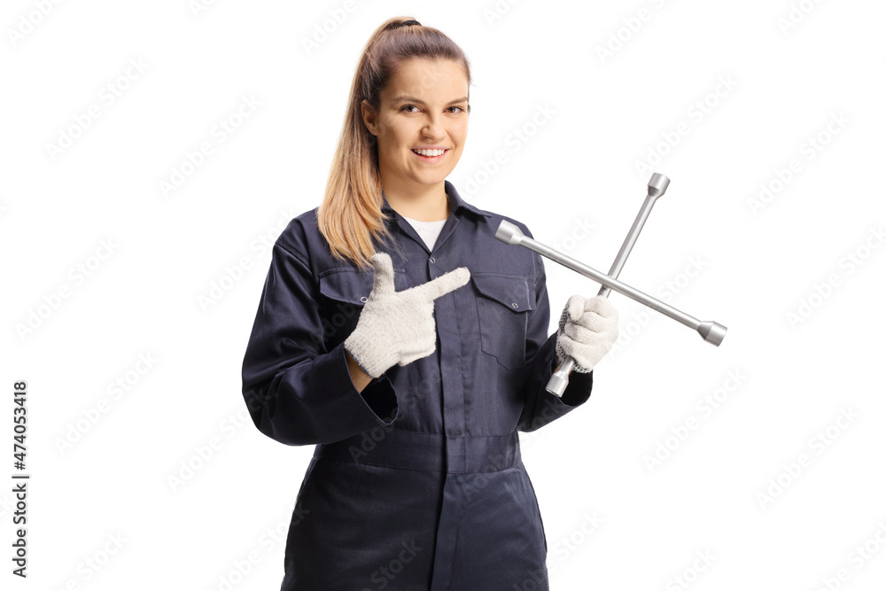 Female car mechanic holding a lug wrench and pointing Female car mechanic holding a lug wrench and pointing