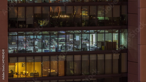 Big glowing windows in modern office buildings timelapse at night