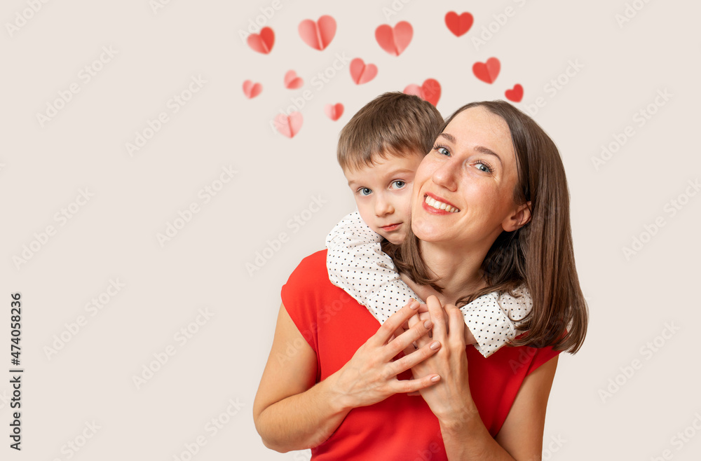 Cute son hugging his mom from behind she smiling. Mother kid relationship Cute son hugging his mom from behind she smiling. Mother kid relationship