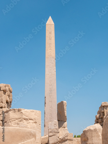 Obelisk at Karnak Temple with Egyptian hieroglyphs and ancient drawings. Luxor, Egypt. Vertical.