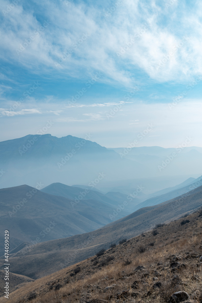 Panoramic view on the mountains and hills with clouds and fog