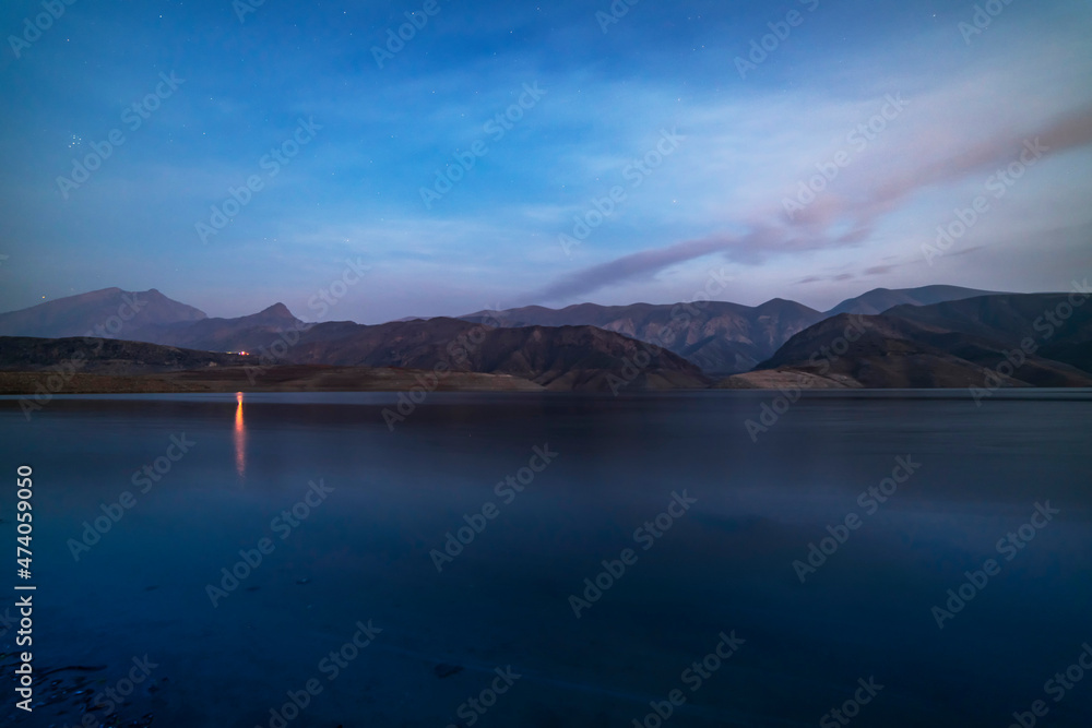 Beautiful lake in the mountains after  sunset.