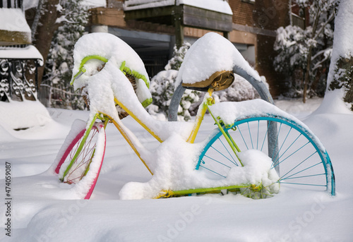 Halifax, Canada covered in snow after first snowstorm of season. Colourful bicycle burried in snow