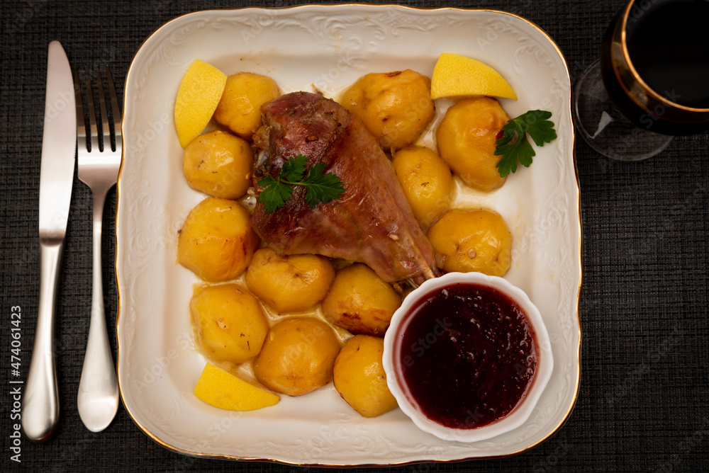 Turkey leg baked with potatoes with cranberry sauce. Delicious food. Turkey leg baked with potatoes with cranberry sauce. Delicious food.