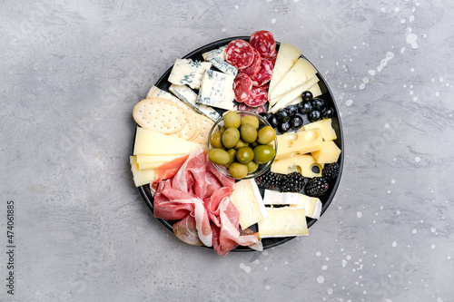 Charcuterie plate with prosciutto, salami, cheese and berries, olives. Aperitif Antipasti Italian cheese parmesan, pecorino, gorgonzola